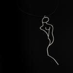 A silver wire pendant shaped like a stylized female silhouette on a black cord.