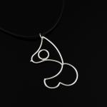 Photograph of a minimalist silver wire pendant shaped like a female form on a black cord.